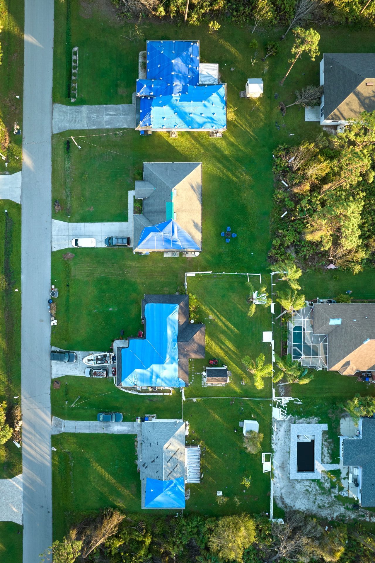 Aerial View Of Damaged In Hurricane Ian Houses Roofs Covered